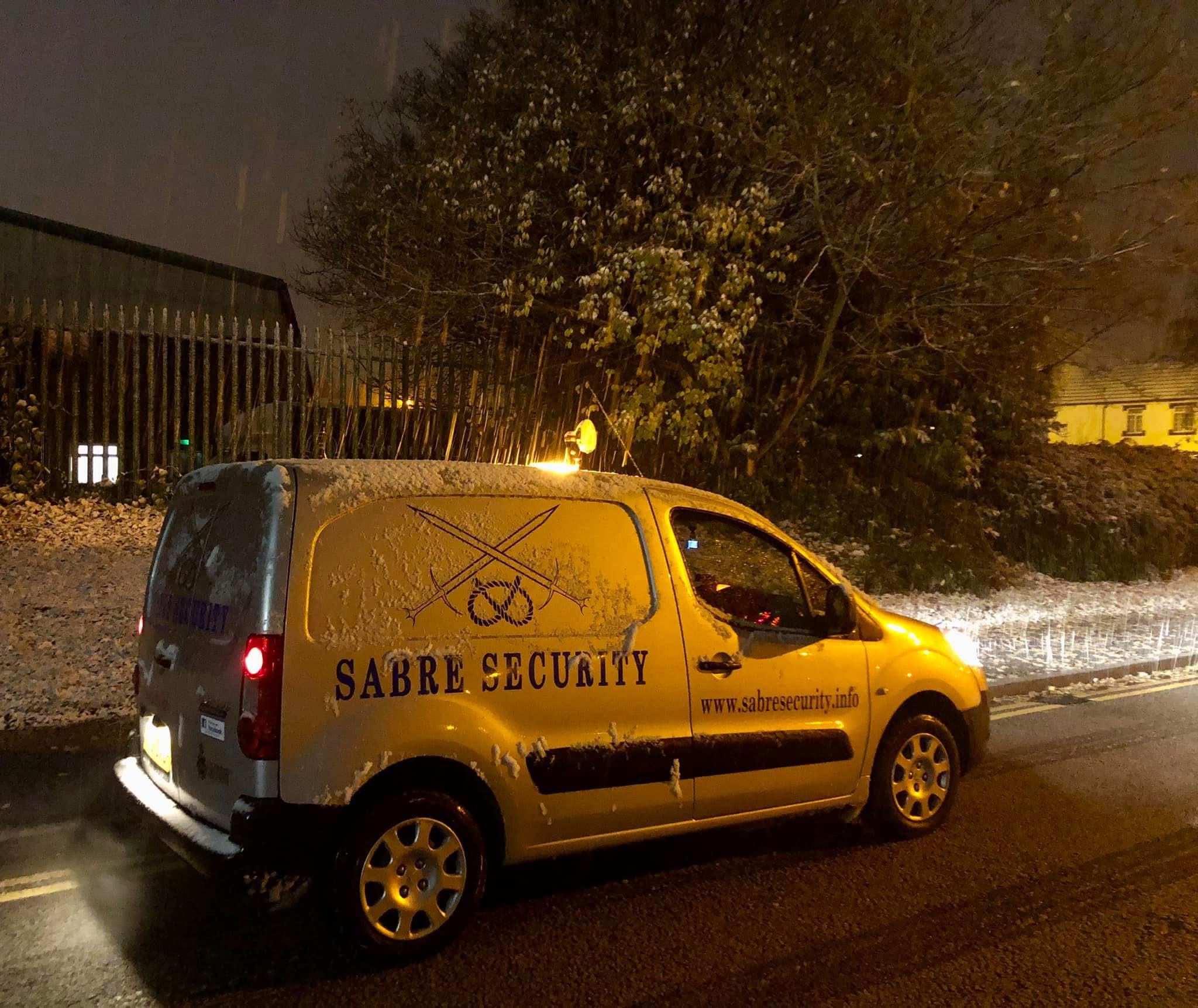 Sabre Security patrol van on a snow-covered site at night